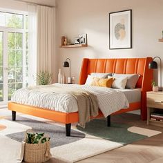 an orange bed frame in a white bedroom