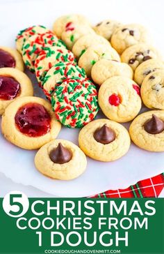 christmas cookies with chocolate and sprinkles are on a white plate next to a red plaid napkin