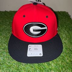 Nike Uga Dawgs Georgia Bulldogs Baseball Team Issued Fitted Cap Hat Red Nike Baseball Cap Snapback, Nike Baseball Cap, One Size Fits Most, University Red Casual Snapback Hat, Casual University Red Snapback Hat, Nike Adjustable Snapback Baseball Cap, Collegiate Red Snapback Fitted Hat, Red Flat Brim Fitted Hat For Outdoor, Red Fitted Cap For Fan Gear, Red Flat Brim Baseball Cap For Fans