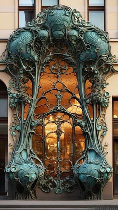 an intricately designed window on the side of a building with glass doors and windows