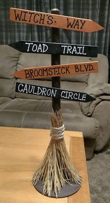 a wooden sign sitting on top of a table in front of a couch and chair