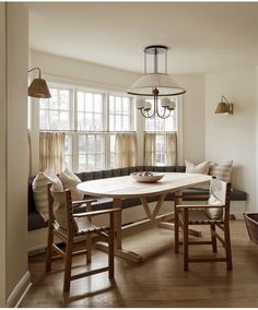 a dining room table with chairs and a bench