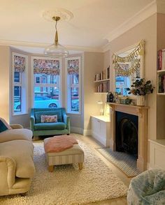 a living room filled with furniture and a fire place in front of a window next to a fireplace