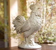 a statue of a rooster on a table