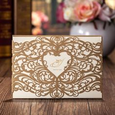 a wedding card with a heart cut out on it sitting on a table next to some books