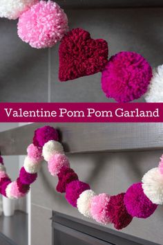 valentine's day pom - pom garland hanging on the fireplace mantel