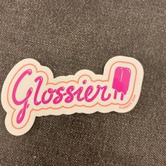 a close up of a sticker with the word glosser on it's side