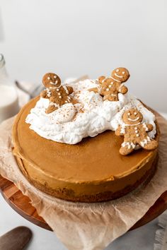 a cake topped with frosting and ginger cookies