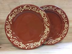 three brown plates sitting on top of a wooden table