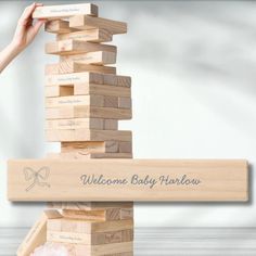 a wooden block tower with the words welcome baby fabulous on it