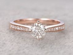 a rose gold engagement ring with diamonds on it