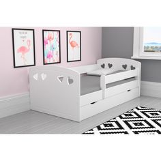 a child's bed with two drawers and a trundle on the floor