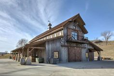 a large wooden building sitting on the side of a road