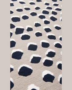 an area rug with black and white spots on it