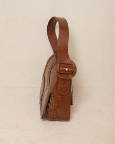 Trivia bag by Kiko Kostadinov in mahogany brown. The signature handbag silhouette from Kiko Kostadinov, presented in deep mahogany calf leather with intricate brogue detailing around the edges. Foldover flap with magnetic closure main compartment. Born in Bulgaria and based in London, Kiko Kostadinov launched his eponymous womenswear line in 2018, delving into an avant-garde aesthetic with innovative fabrics and architectural silhouettes. With Australians Laura and Deanna Fanning at the creative Avant Garde Aesthetic, Jersey Cardigan, Kiko Kostadinov, Christian Wijnants, Mahogany Brown, Unisex Dress, Shield Sunglasses, Wallet Accessories, Style Profile