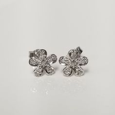 "Thanks for shopping our vintage estate store. We tend to sell well below wholesale and truly hope you enjoy all of our items. Many of the items are one of a kind, so please enjoy scrolling through the pictures and hopefully something will catch your eye. Brown spots are from camera or reflections. Nice estate 10k white gold .10ct diamond stud pedal flower earrings.  There are 8 diamonds for each earring, beautiful setting, some that you will love.  Setting: 7mm 1/4\" Weight: 0.70 grams Carat: .025ct per stud Clarity: I2 Color: H Marked 10k and backs are included. 16 diamonds for the pair." Sterling Silver Flower Diamond Earrings For Anniversary, Flower-shaped Earrings With Sparkling Stones For Anniversary, Diamond White Flower-shaped Earrings For Anniversary, Flower-shaped Sterling Silver Diamond Earrings With Accents, Dazzling Silver Flower-shaped Earrings, Flower Pedals, Diamond Earrings Studs, Diamond Studs, Flower Earrings