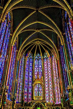 the inside of a cathedral with stained glass windows