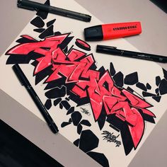 some type of graffiti on a piece of paper with marker pens and markers next to it