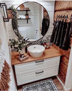 a bathroom with a sink, mirror and towel rack on the wall in front of it