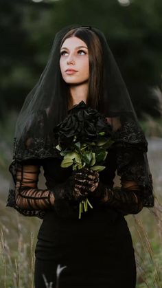 a woman wearing a veil and holding flowers