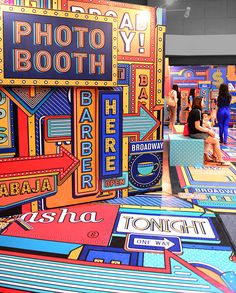 an art exhibit with many different signs on the floor