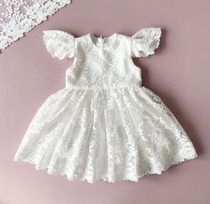 Baptism Dress With Short Sleeves.  This dress is made of natural cotton and elegant floral lace. The colour is ivory.  The inside of the dress is lined of natural cotton so your baby girl will feel comfortable. It has a cozy zipper in the back. Choose from size newborn  to 3T.  Please, check attentively all your measurements at the size chart  on the second photo. If you have specific requests, our team is happy to create a custom dress for you. You can order all the matching outfit: bonnet, headband, booties, bloomers, blanket. Link for : *bonnet: https://www.etsy.com/listing/785768002/baptism-bonnet-lace-bonnet-baptism-baby?click_key=0901abbc1c12db427f8509d71a98750c1773883c%3A785768002&click_sum=cecc4772&ref=shop_home_active_4&frs=1&sts=1 *headband: https://www.etsy.com/listing/140976942 Outfit Bonnet, Girl Baptism Dress, Christening Blanket, Girls Baptism Dress, Dress For Baby Girl, Lace Bonnet, Girl Baptism, Beautiful Museum