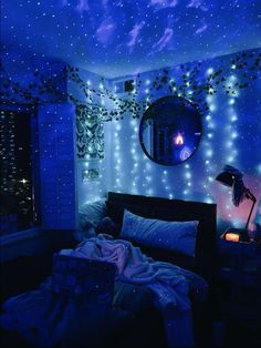 a bedroom with blue lights on the ceiling and stars in the sky over the bed