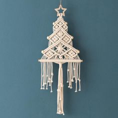 a small white christmas tree hanging from a wall