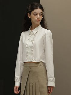 Editor's NotesDUNDROP displays timeless and classic styles with feminine details- Feminine blouse- Cropped length- Ruffled detail at the placket- Double buttonsMeasurements(in.)Size: S / M- Length: 16.9 in. / 17.3 in.- Bust: 39.8 in. / 41.3 in.- Shoulder: 14.6 in. / 14.9 in.- Sleeve: 24.4 in. / 24.8 in.* Model info: height 5' 7, Fitting size SComposition & Care- 100% cotton- Hand wash or dry cleaningDesigner- by DUNDROP Elegant Workwear Shirt With Ruffled Collar, Timeless Collared Tops For Office, Feminine Office Shirt With Ruffled Collar, Classic Office Shirt With Ruffled Collar, Classic Shirt With Ruffled Collar For Office, Classic Ruffled Shirt For Office, Classic Collared Semi-formal Shirt, Classic Semi-formal Shirt With Collared Neckline, Semi-formal Spread Collar Blouse For Spring