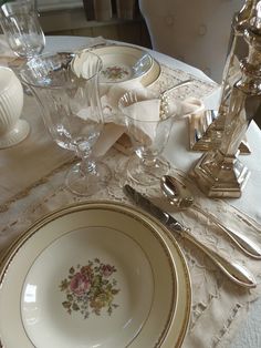 the table is set with dishes and silverware