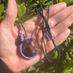 Amethyst Moon Pendant, a one-of-a-kind piece that will elevate any outfit. Handmade by me, this pendant features a beautiful dark purple and brown Amethyst moon crystal set on a micro macrame necklace with an adjustable length. The waxed polyester cord and bead accents add a touch of elegance to this statement piece, making it perfect for any occasion. Add this unique pendant to your collection today and feel the beauty and power of Amethyst. Adjustable Hand-wrapped Amethyst Crystal Necklace, Mystical Handmade Adjustable Crystal Necklaces, Handmade Adjustable Mystical Crystal Necklace, Mystical Handmade Adjustable Crystal Necklace, Adjustable Hand Wrapped Mystical Necklace, Adjustable Amethyst Pendant Crystal Necklace, Handmade Adjustable Amethyst Necklace, Adjustable Crystal Necklace With Moon Charm For Healing, Adjustable Hand-wrapped Amethyst Necklaces