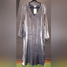 H&M Shiny Silver Dress. A-Line Cut Slight Bell Sleeves Lightweight V Neck Sized Small, But The Loose Fit Could Go Up To A Large. H&M Conscious Choice H&m V-neck Party Dress, H&m V-neck Midi Dress For Fall, H&m V-neck Dress For Fall, H&m Knee-length Party Midi Dress, H&m V-neck Fall Dresses, H&m Long Sleeve Party Midi Dress, Long Sleeve H&m Midi Dress For Party, H&m Long Sleeve Midi Dress For Party, Shiny Silver Dress