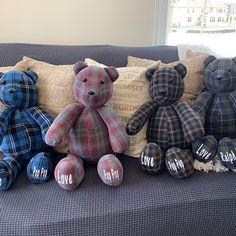 four teddy bears are sitting on the couch