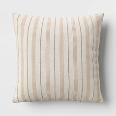 a striped pillow on a white wall