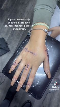 a woman's hand with writing on it and her name written on the wrist