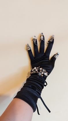 This model is unique and will not be repeated! Made of satin with crystals. The glove size is suitable for light to medium hands! ship immediately with express delivery. Please enter your phone number when ordering, the postal company requires it. All products are made in Europe with high quality workmanship. I use professional materials for manicure and nails. Make a statement with these mesmerizing burlesque nail gloves! Designed for the bold and daring, these gloves are adorned with metallic Elegant Jewelry For Cosplay, Elegant Black Jewelry For Cosplay, Elegant Adjustable Jewelry For Cosplay, Elegant Black Jewelry For Costume Party, Elegant Adjustable Jewelry For Costume Party, Gothic Metal Bracelets For Party, Gothic Bracelets For Halloween Party, Luxury Rhinestone Bracelets For Party, Black Crystal Bracelets For Party