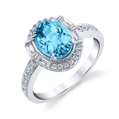 Crafted from exquisite 14k white gold, this stunning ring features a magnificent blue topaz as its primary gemstone, accented with sparkling diamonds as secondary and tertiary gemstones. This luxurious piece boasts a total carat weight of 2.73, making it a truly dazzling addition to any jewelry collection. Luxury Blue Topaz Diamond Ring With Diamond Accents, Luxury White Topaz Fine Jewelry Ring, Luxury White Gold Diamond Ring With Blue Topaz, Luxury Dazzling White Gold Topaz Ring, Luxury Diamond Ring With Blue Topaz And Diamond Accents, Luxury Dazzling Topaz Ring With Gemstone Accents, Luxury White Gold Ring With Blue Topaz, Luxury Dazzling White Topaz Diamond Ring, Luxury White Topaz Ring With Diamond Accents