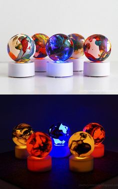 four different colored balls sitting on top of each other