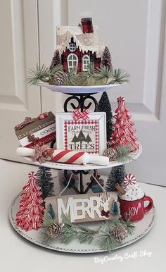 three tiered tray with christmas decorations on it