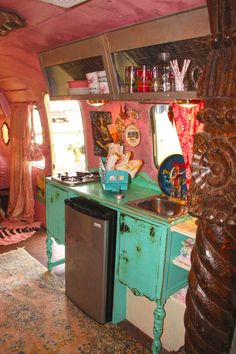 a kitchen area with a sink, dishwasher and refrigerator