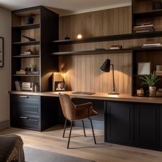 a home office with dark wood paneling and built - in shelving, lighting up the room