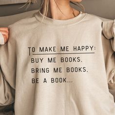 a woman wearing a sweatshirt that says, to make me happy buy me books bring me books be a book