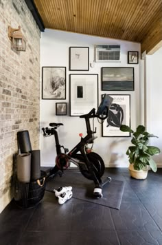 there is a bike in the room with pictures on the wall