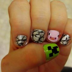 a person with some nail art on their fingers and one has a pig in the middle