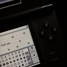 a close up of a remote control with buttons and symbols on the screen in front of it