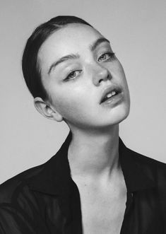 a black and white photo of a woman with her head tilted to the side looking up