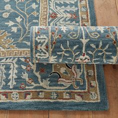 a blue rug with animals on it laying on the floor