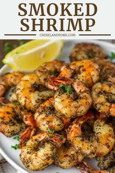 grilled shrimp on a plate with lemon wedges and parsley garnish