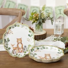 there are many plates on the table with deers and flowers in front of them