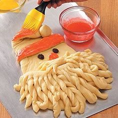 a person is decorating some kind of thing with macaroni noodles and cheese